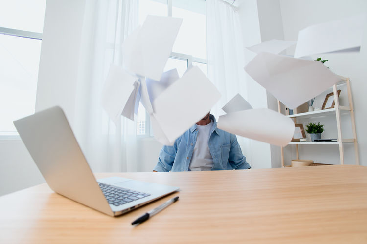 Midsection of woman using laptop on table