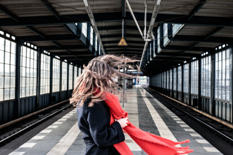 Woman standing on railroad station platform