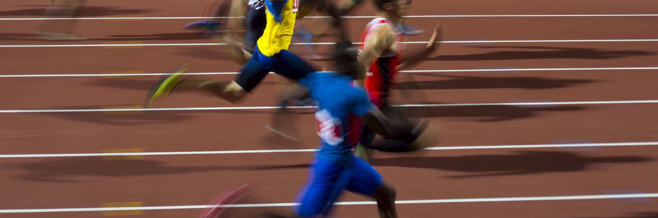 Blurred motion of athletes running on track