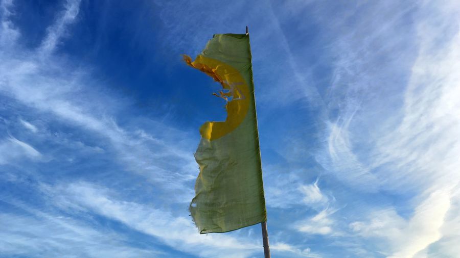 Low angle view of torn flag