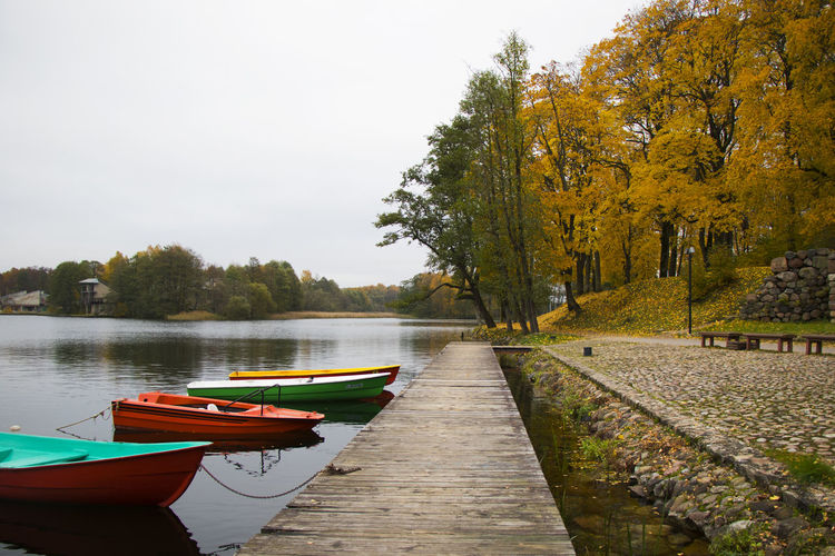 Old wooden boats near the beach of trakai gavle lake, lithuania. autumn and fall time.