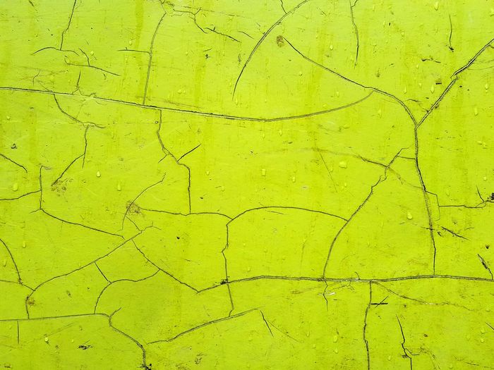 Full frame shot of cracked green wall