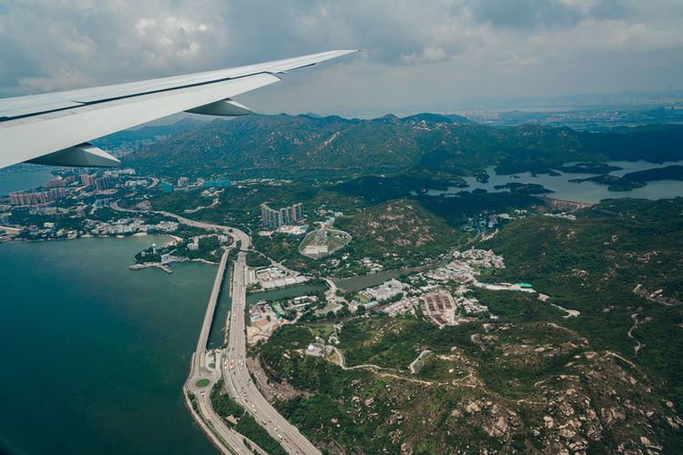 Aerial view of sea and mountains against sky