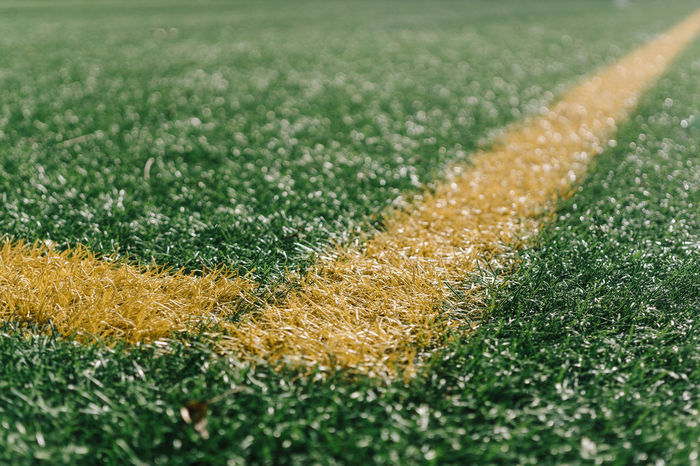 Close-up of yellow yard line on soccer field