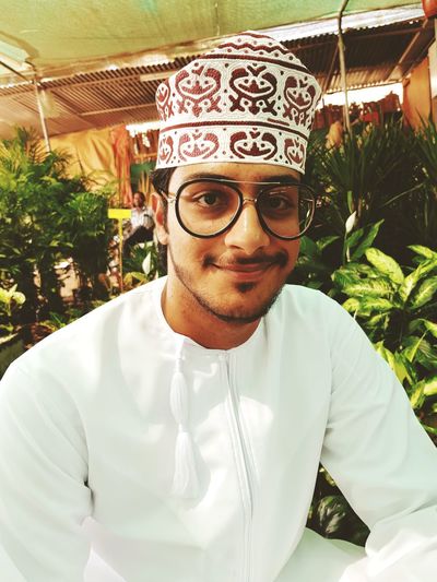 Portrait of smiling man wearing taqiyah during event