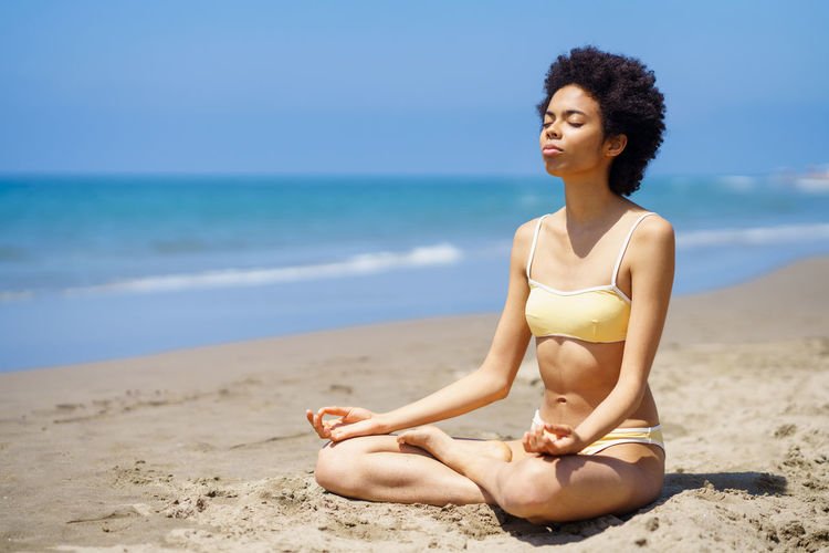 Young woman listening music white meditating