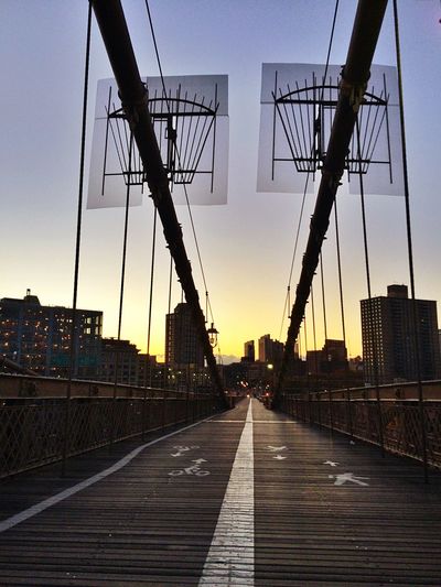 Railroad tracks against sky at sunset
