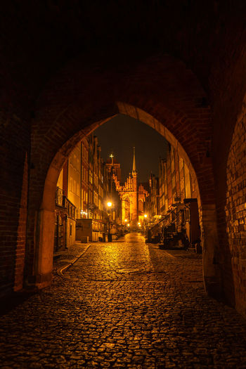 Cityscape of gdansk with st. mary basilica and city hall at night, poland. beautiful architecture of
