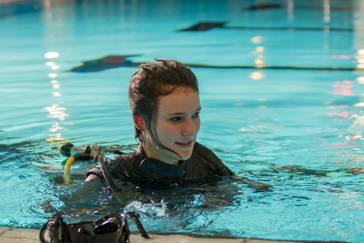 Full length of woman scuba diving in swimming pool