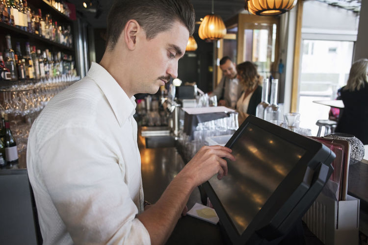 Side view of man working in restaurant