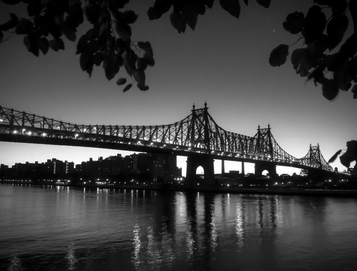 Low angle view of silhouette queensboro bridge over river at night