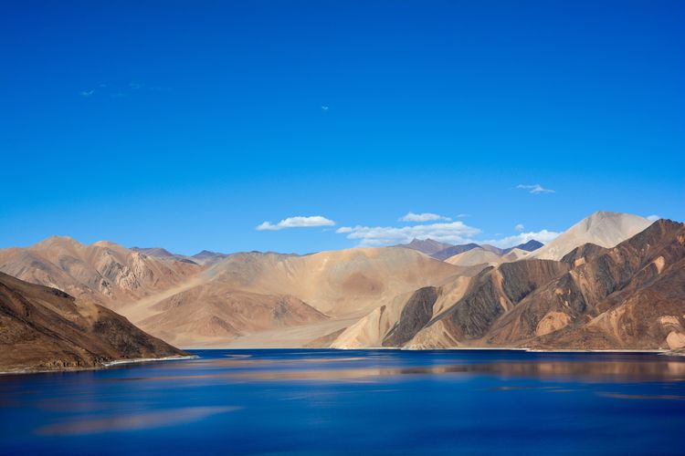 Scenic view of lake against blue sky