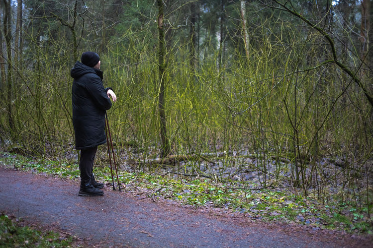 Rear view of man walking on road
