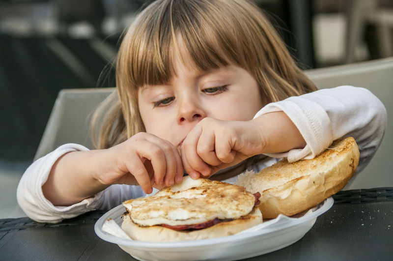 Child eating breakfast sandwich
