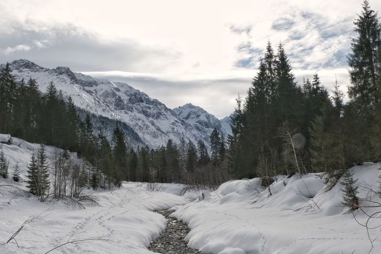Scenic view of snow covered mountains against sky