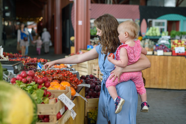 Woman with fruits at market stall