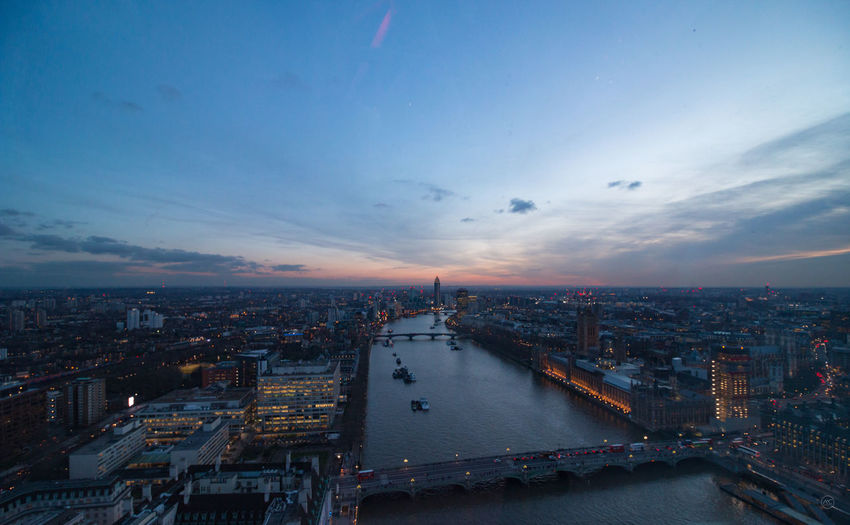 Aerial view of bridge over thames river in city against sky during sunset