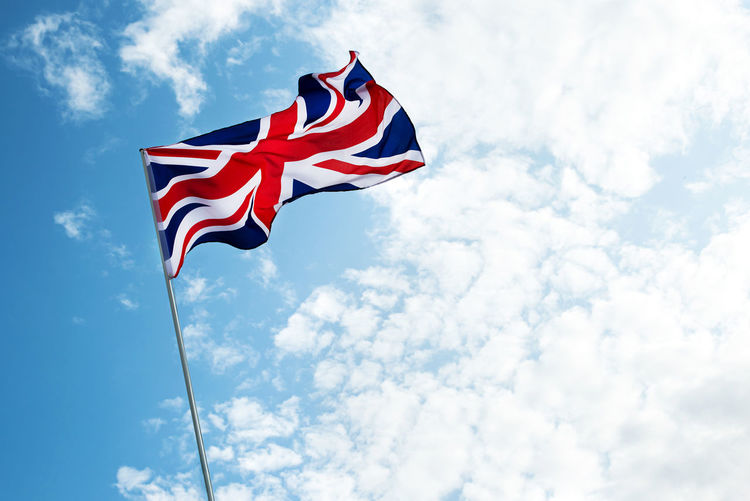 Great britain england flag waving over sky cloudy