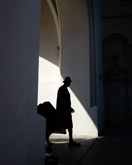 Silhouette man walking in corridor of building