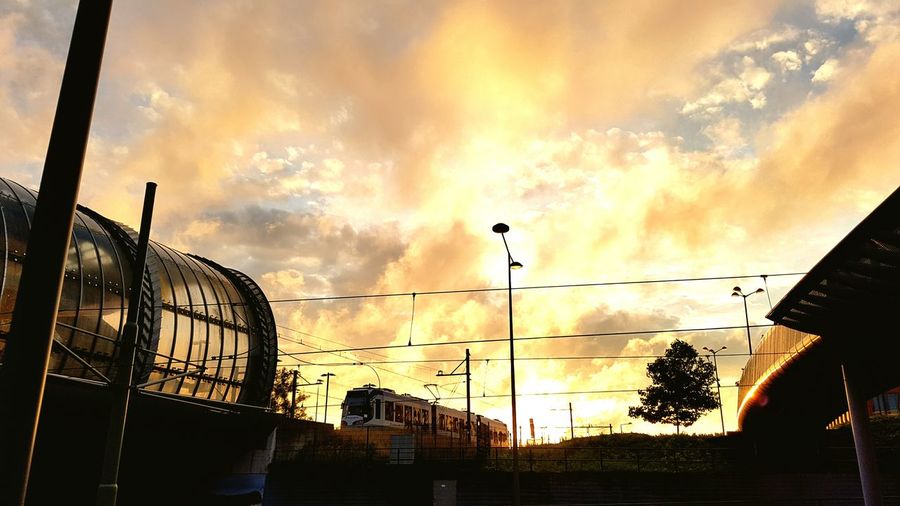 Low angle view of silhouette buildings against sky