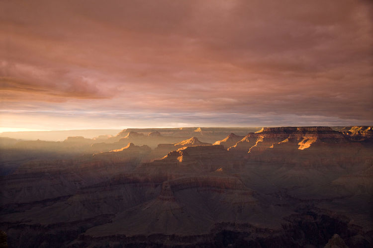 Dramatic sunset at grand canyon with orange and yellow sky