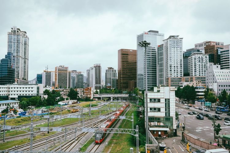 High angle view of railroad tracks in city against sky