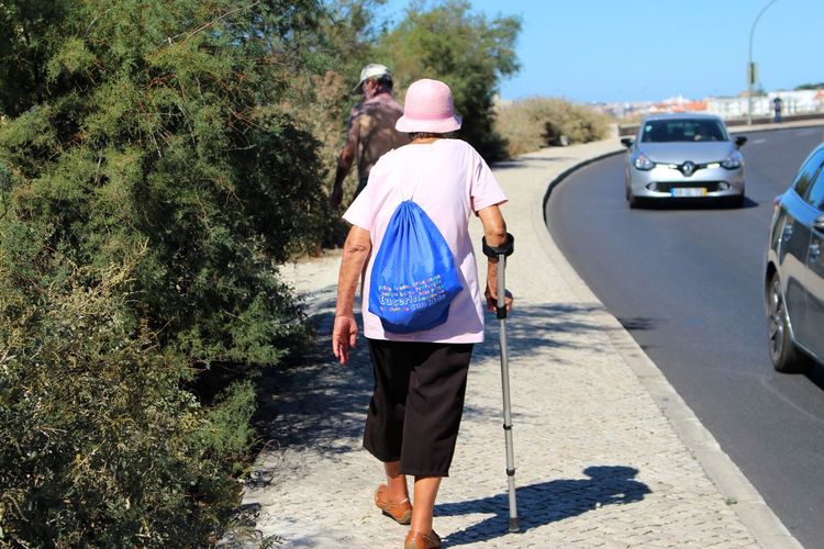 Rear view of friends walking on street