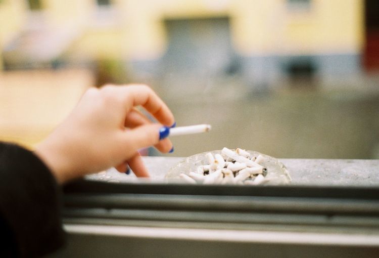 Cropped image of woman hand holding cigarette
