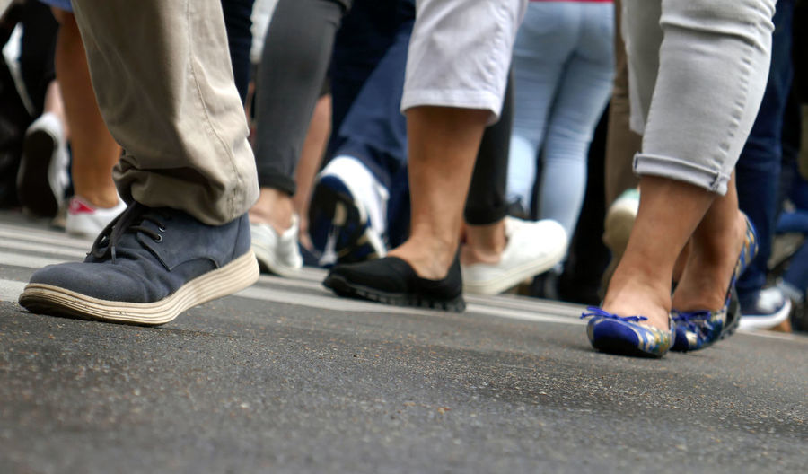Low section of people walking on street