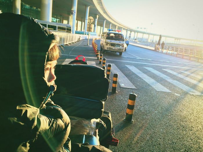 Boy by luggage at airport