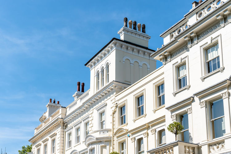 Luxury english victorian houses in notting hill in london against blue sky