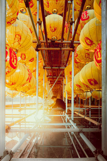 Illuminated lamps hanging in temple outside building