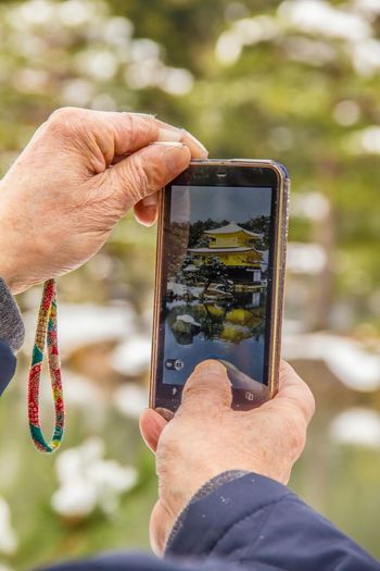 Cropped hand photographing gazebo