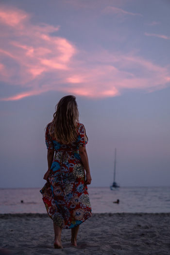 Rear view of woman looking at sea against sky