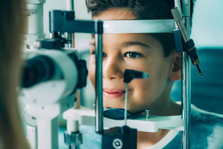 Close-up of ophthalmologist doing eye test of boy