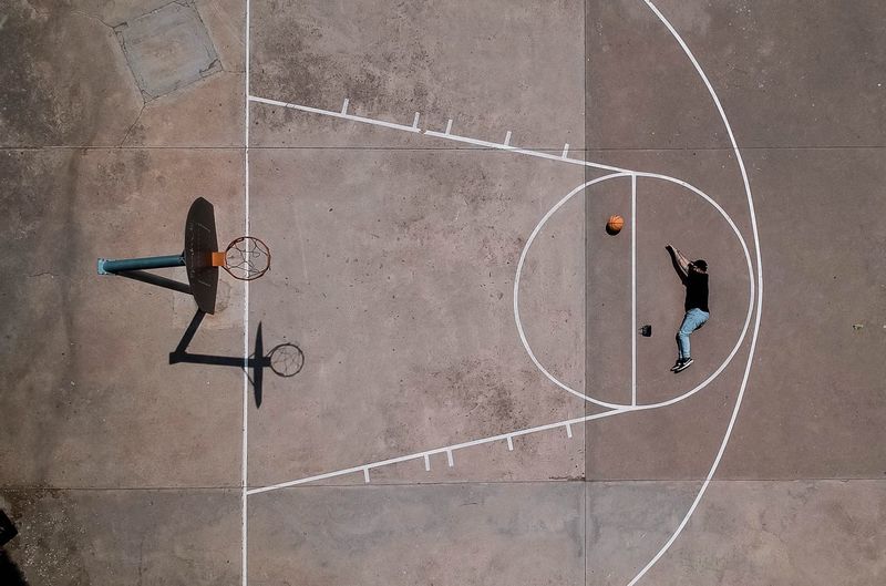 Aerial view of man playing basketball court