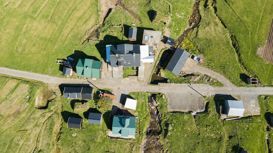 High angle view of houses on field by building