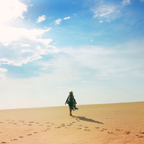 Man standing on sand dune