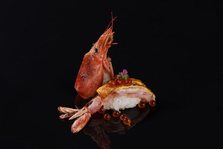 Close-up of crab over black background