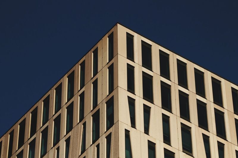Low angle view of office building against clear sky