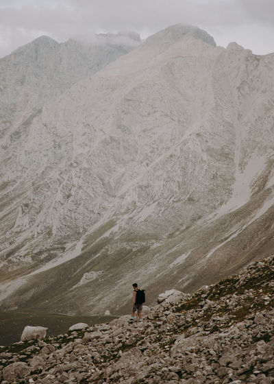 Rear view of man walking down on mountain