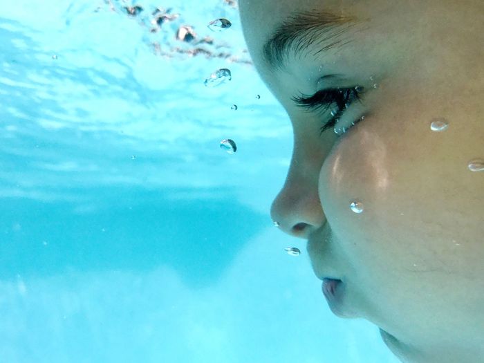 Close-up of girl swimming in water