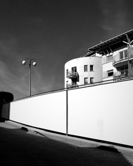 Low angle view of illuminated street light against sky