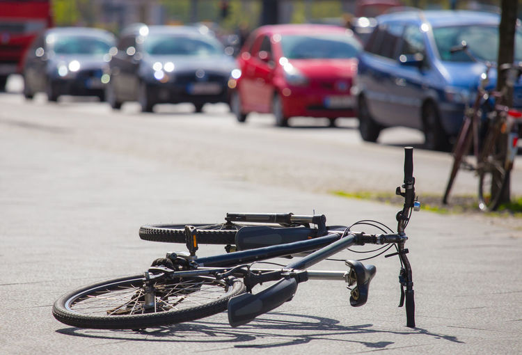 After a traffic accident, a bicycle is lying on a street