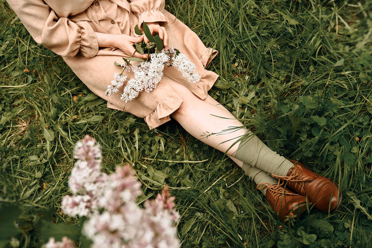 Low section of woman lying on grass