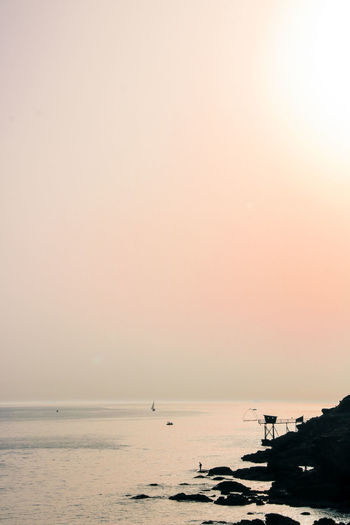 Scenic view of sea against clear sky during sunset