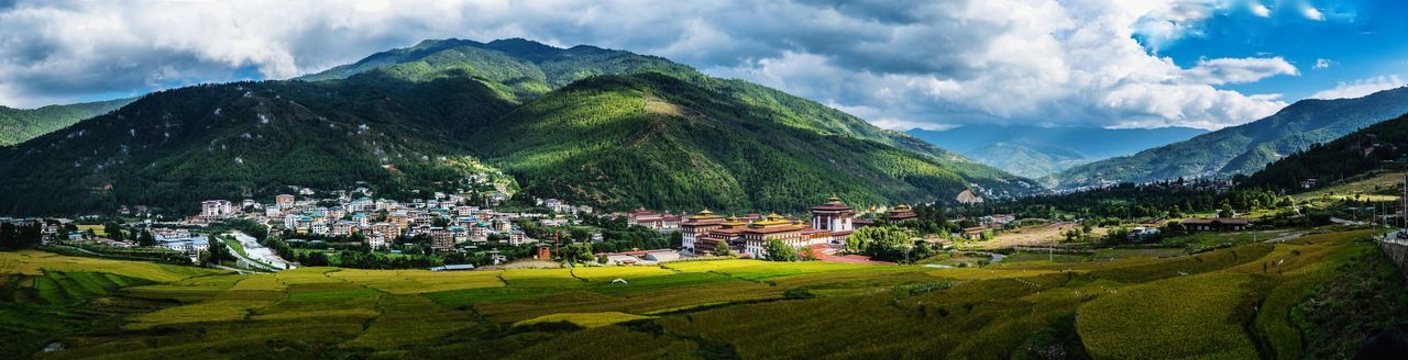 Panoramic view of houses and mountains against sky