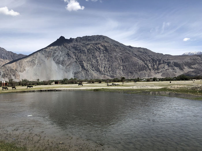 Scenic view of lake and mountains against sky