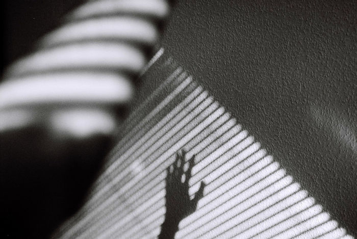 Shadow of cropped hand on wall