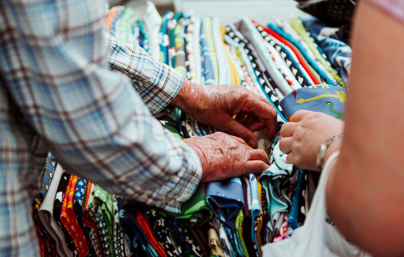 Close-up of people browsing fabrics